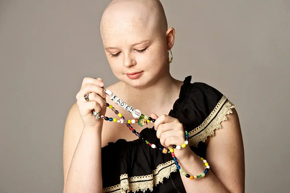 Teen holding a necklace