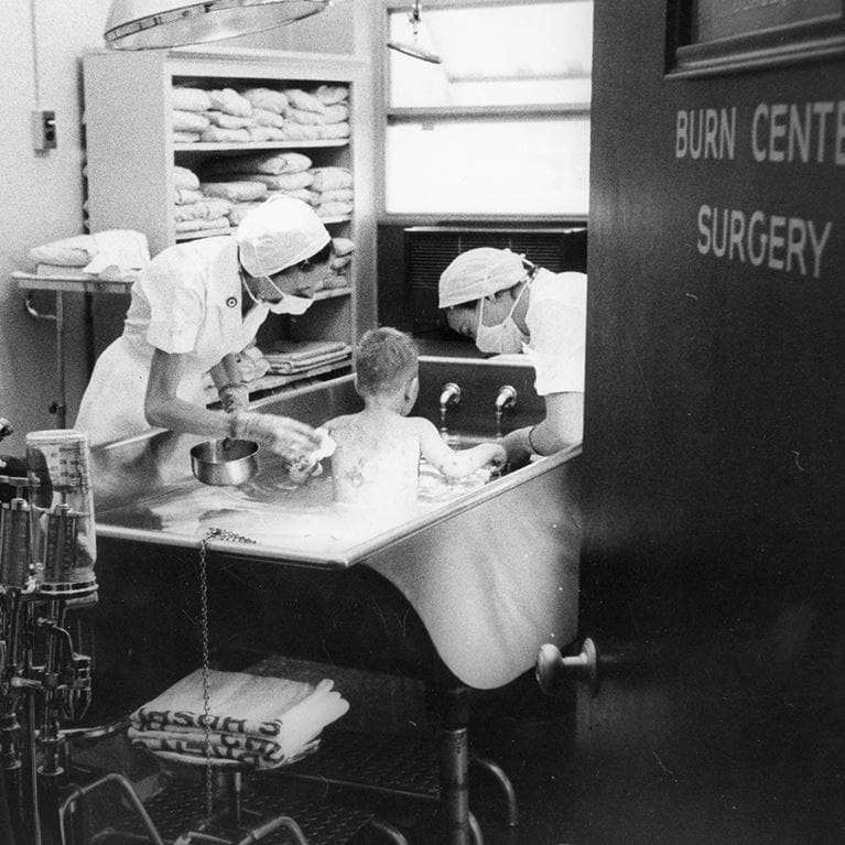 Small child being cared for in burn center surgery.
