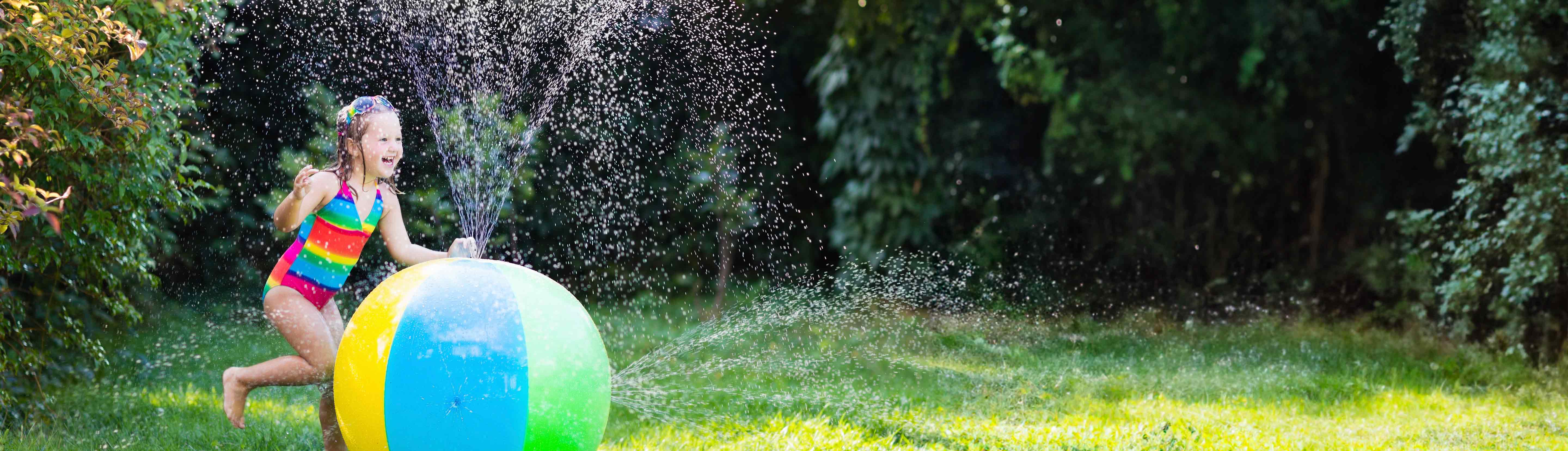 Little girl playing with water toy