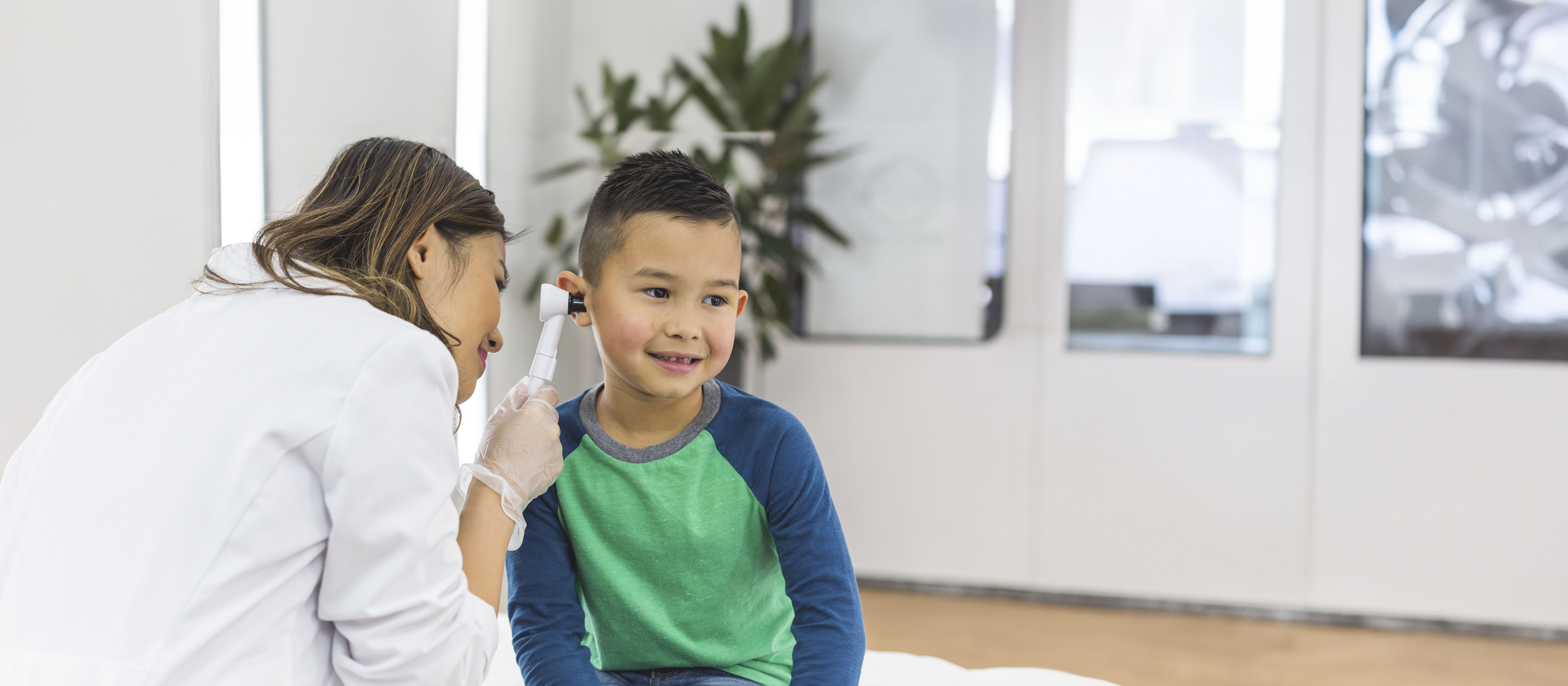 Boy getting ears checked out by doctor