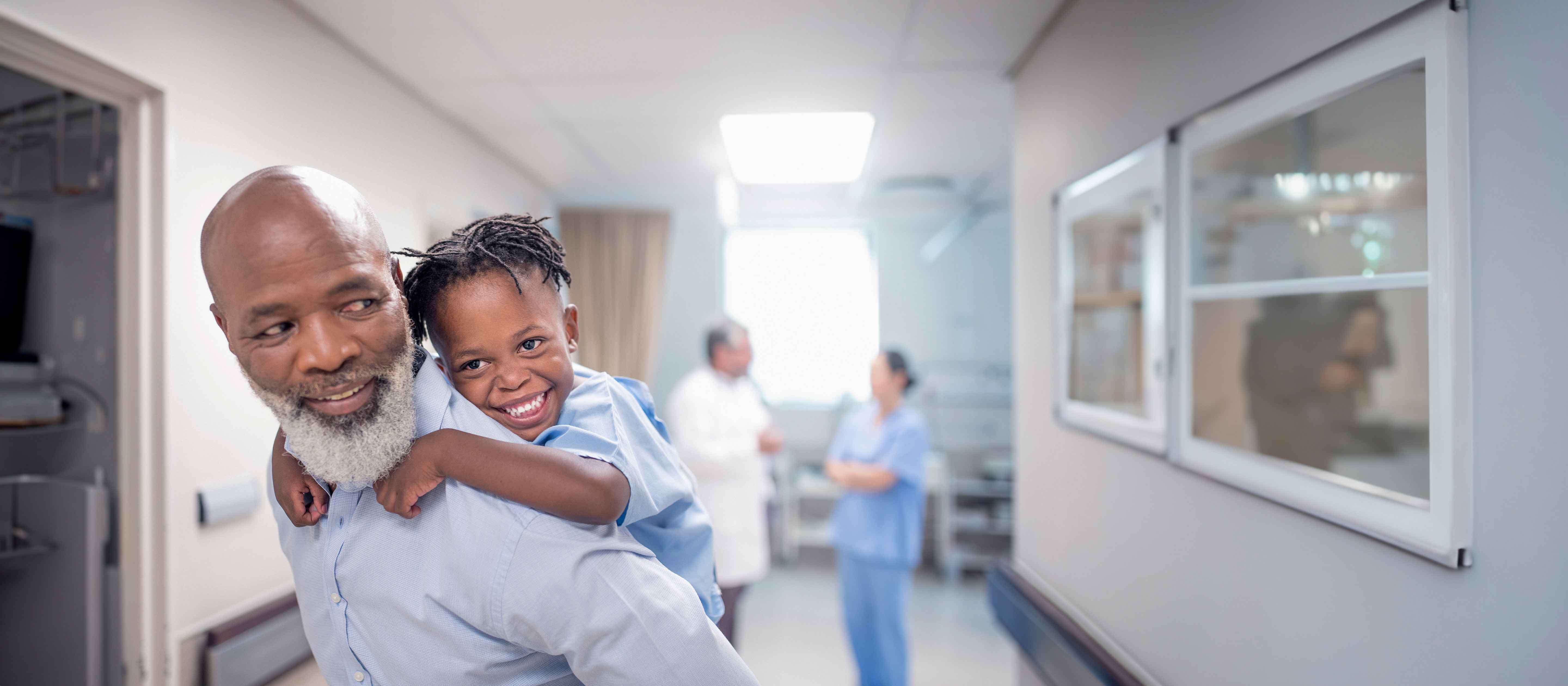 Dad giving son piggy back ride