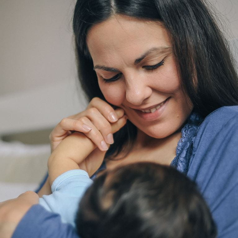 Mother breastfeeding her child.