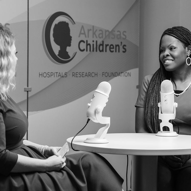 Black and white image of Elaine Odiase, M.D. being interviewed. 