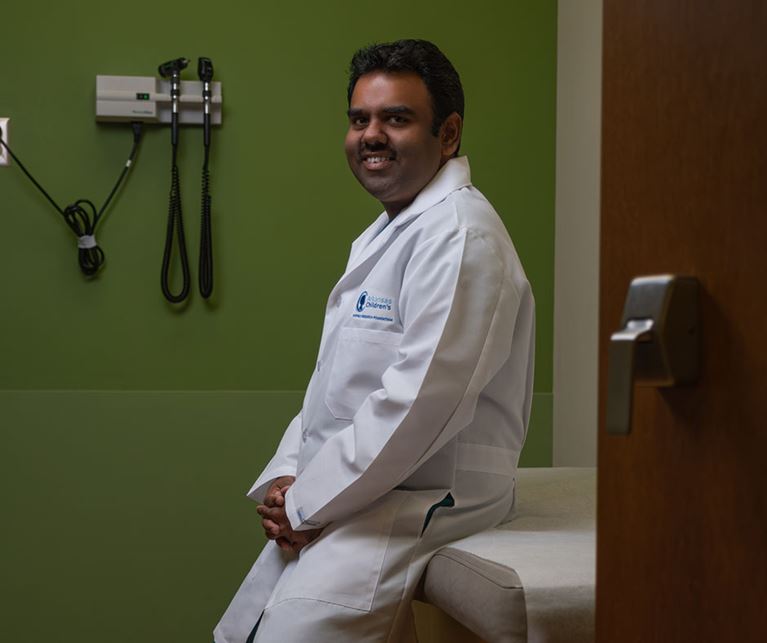 Dr. Panda in clinic room wearing white coat.