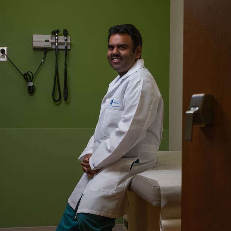 Dr. Panda in clinic room wearing white coat.