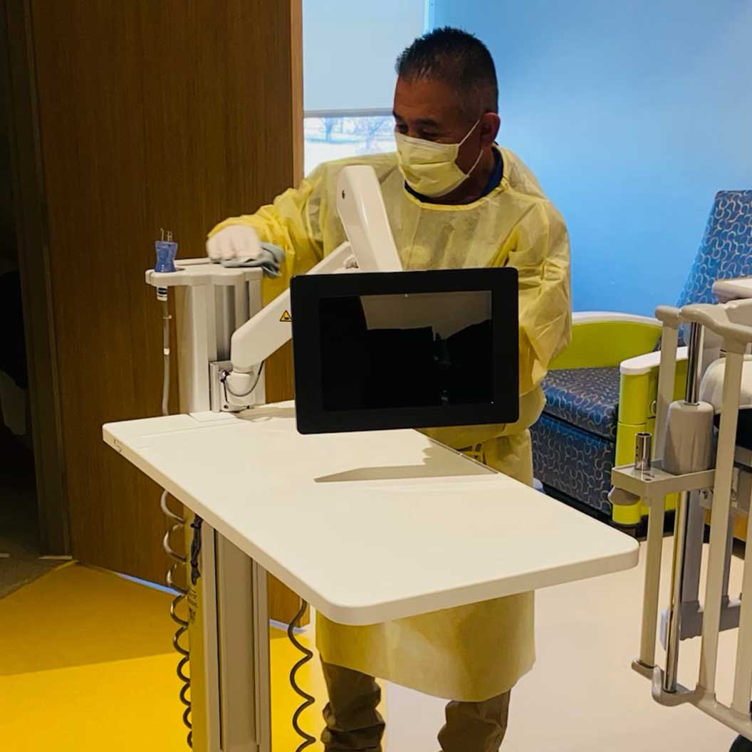 Image of a team member cleaning in patient room.