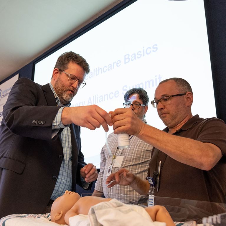 Dr. Ashley Ross demonstrating procedure on manikin. 