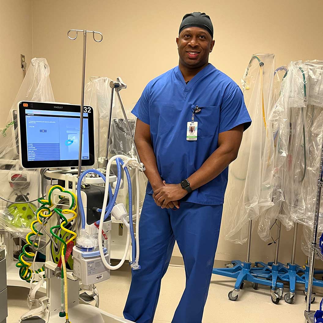 Image of male employee wearing blue scrubs.