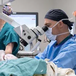 Dr. Strub performing ear tube procedure on patient.