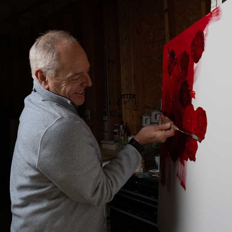 Dr. Stanford painting with the color red.
