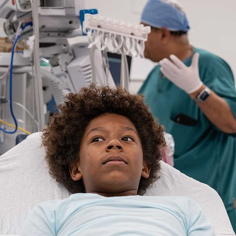 Tween boy awake before surgery in operating room.