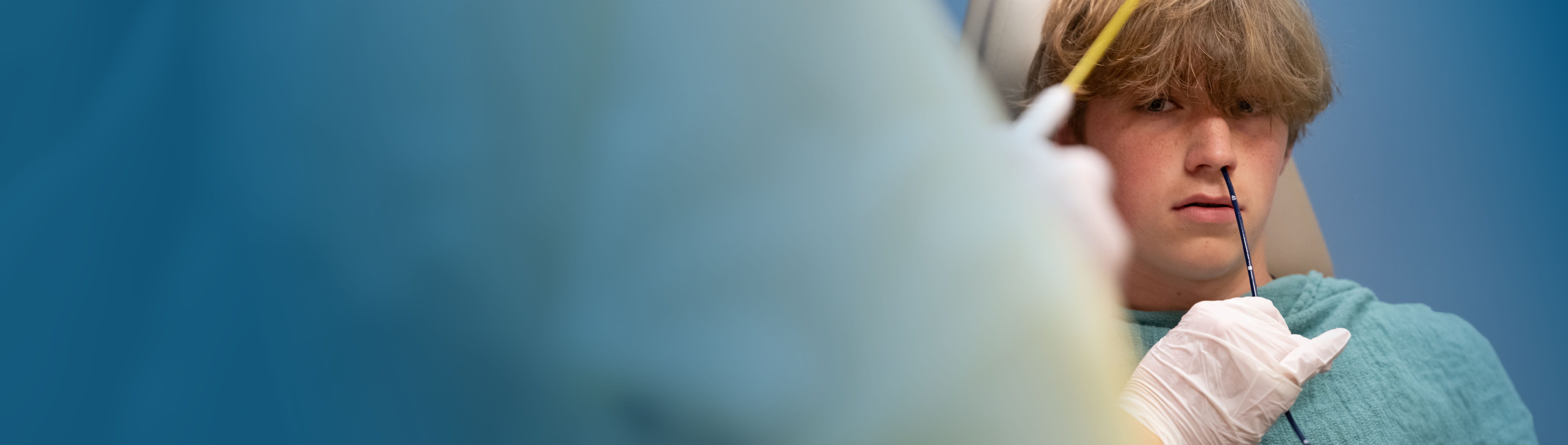 Male patient having procedure in clinic setting.