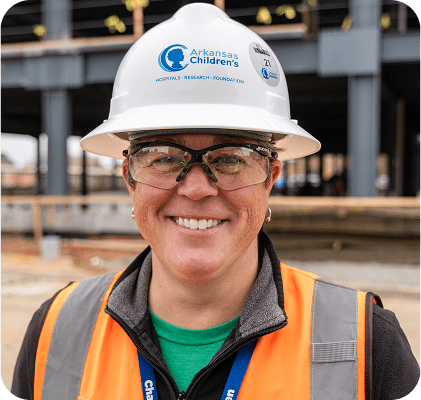 Employee wearing hard hat in construction area.