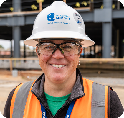 Employee wearing hard hat in construction area.