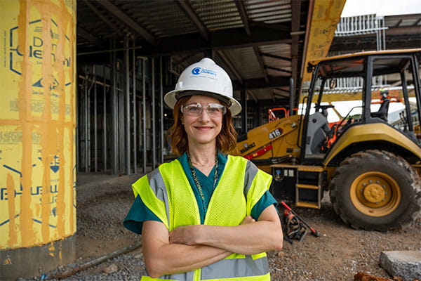 Dr. Dotson standing in construction zone wearing hard hat.