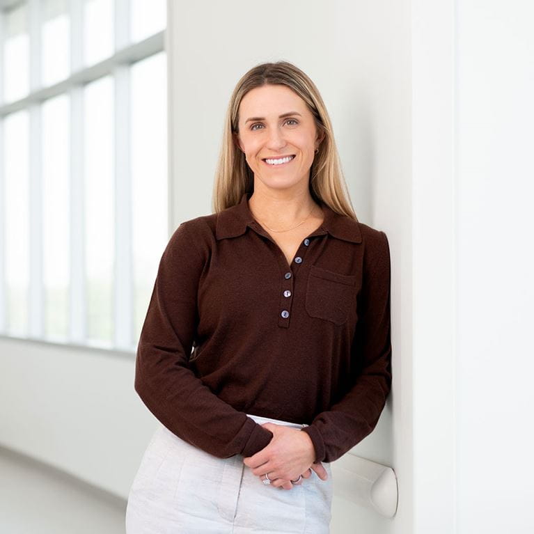 Dr. Adrienne Koder standing in hospital hallway.