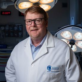 Dr. Todd Maxson wearing white coat.