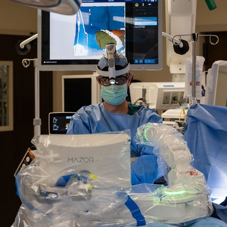 Surgeon in operating room using Mazor robot - BL