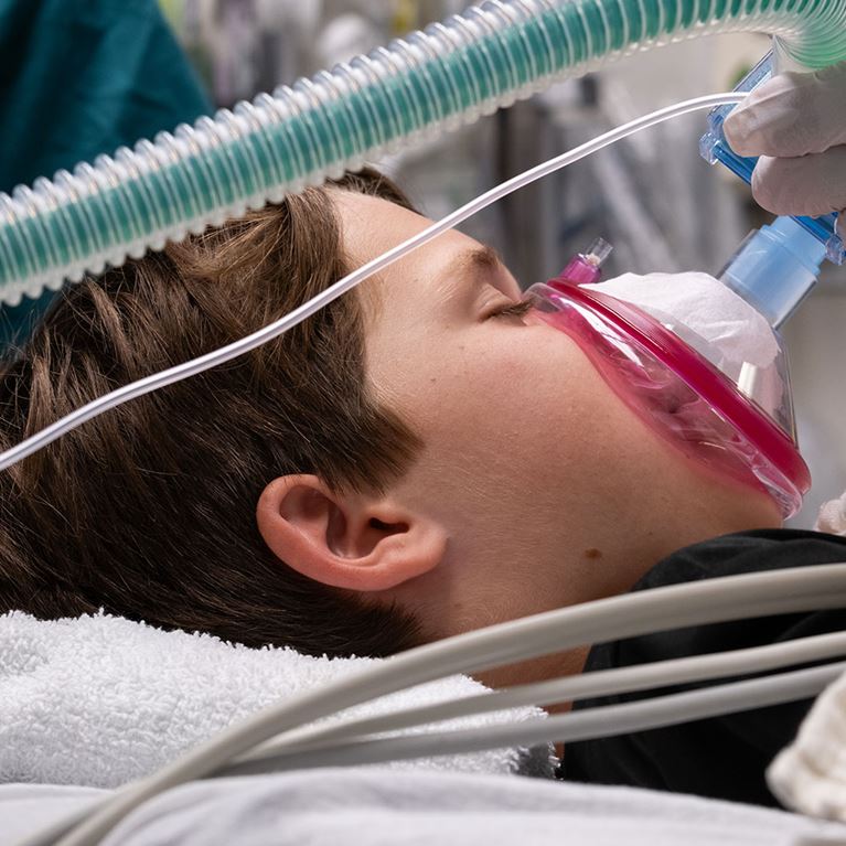 Male patient wearing mask in operating room.
