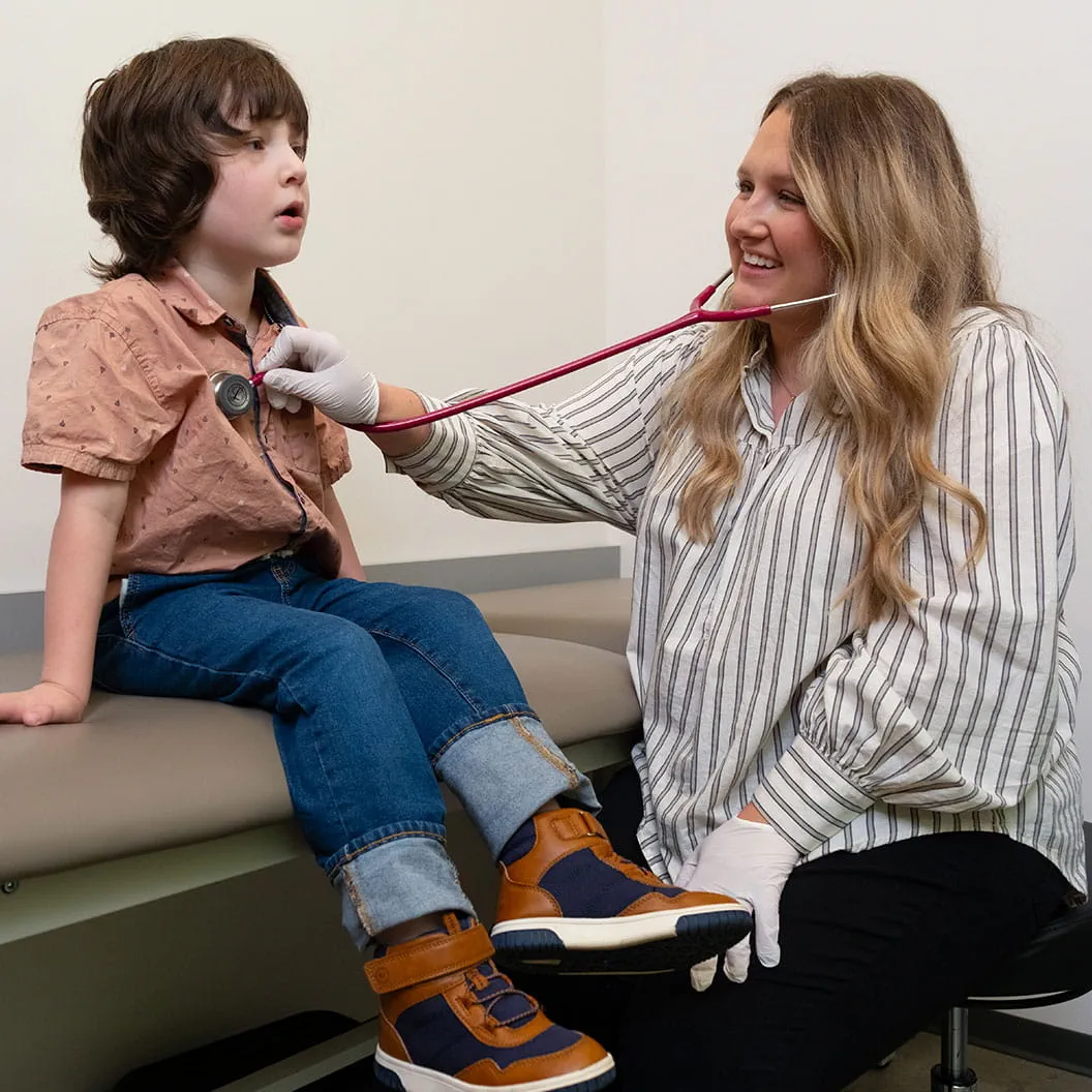 Pediatric patient being seen in clinic by doctor.