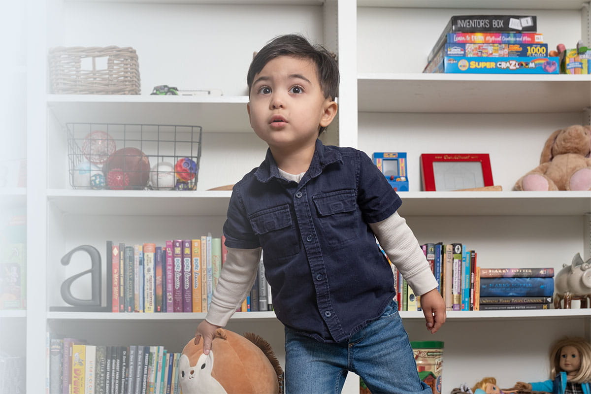 Toddler boy in playroom at home.