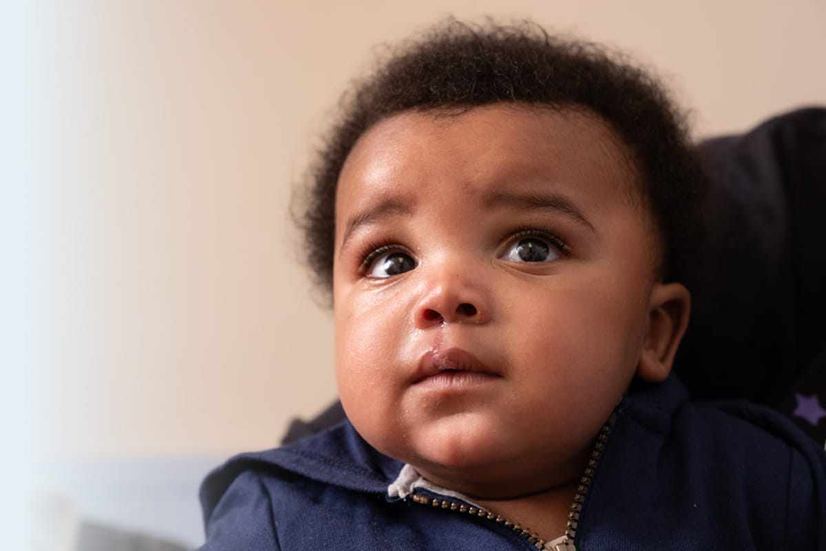African American boy in blue jacket.