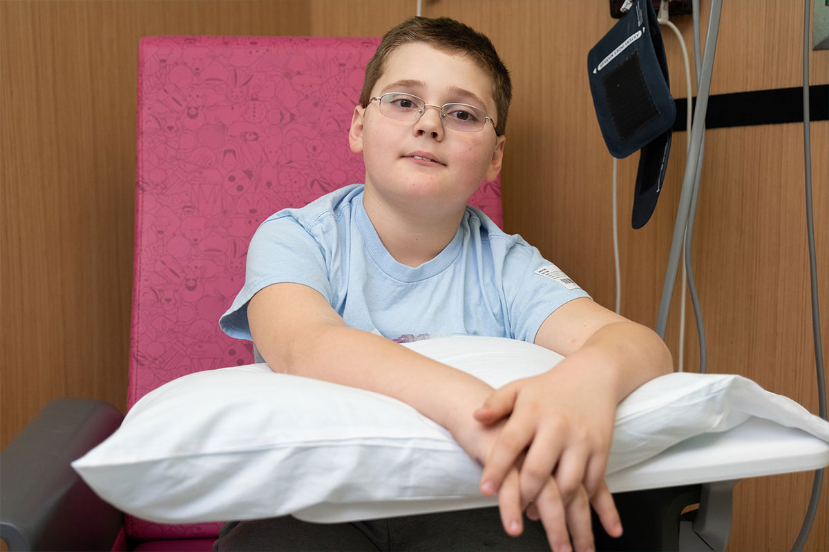 Male patient wearing blue shirt sitting in clinic chair.