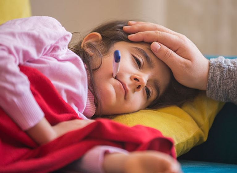 Sick girl with a thermometer