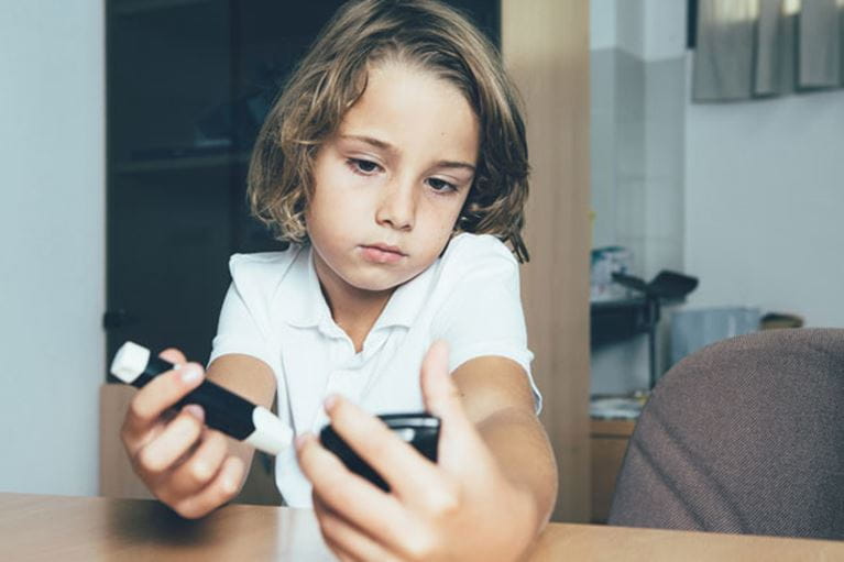 Photo of a child checking blood sugar