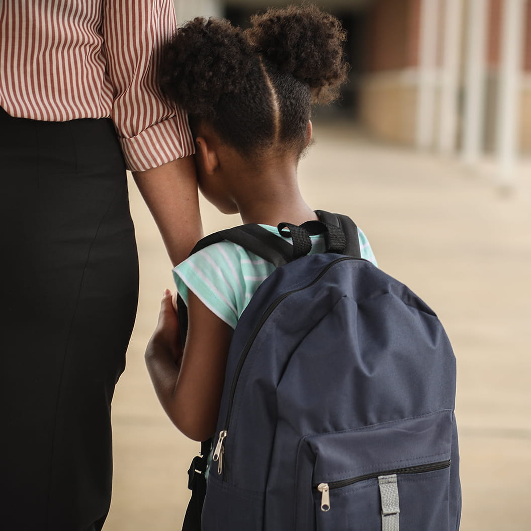 Young female student with head rested on teachers arm