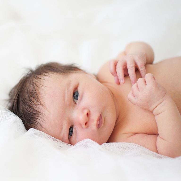 Infant on white blanket
