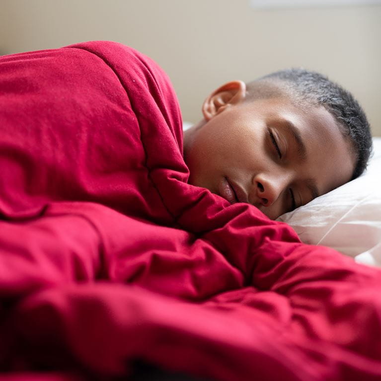 Boy sleeping in bed