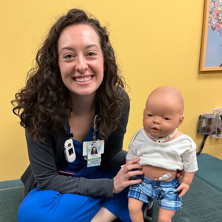 Child Life Specialist holding teaching doll