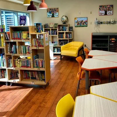 Hospital classroom with bookshelves and tables
