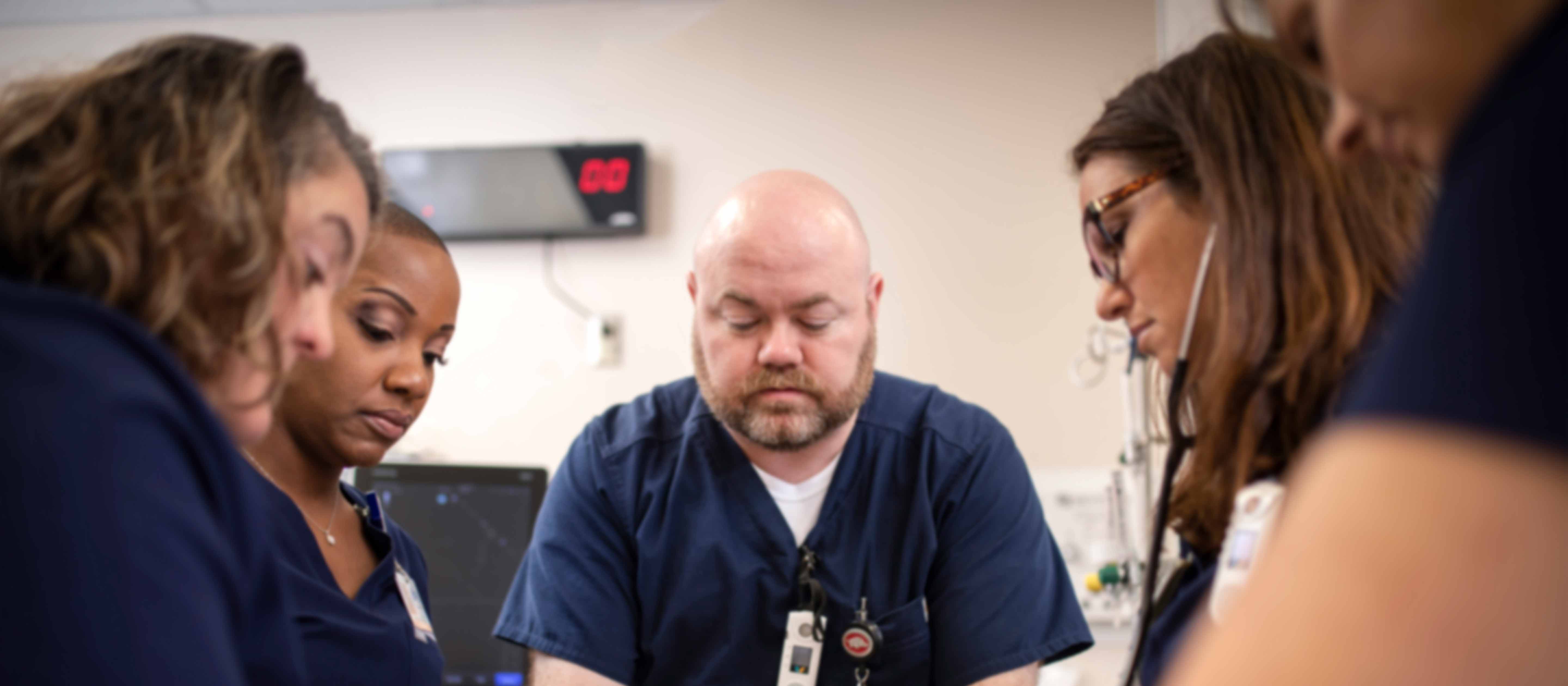 Group of clinical employees looking at documents.