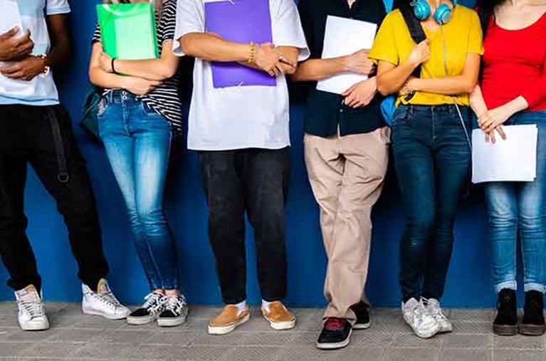 Legs of teenagers who are haning out.