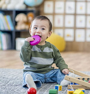 Toddler Chewing on Toy