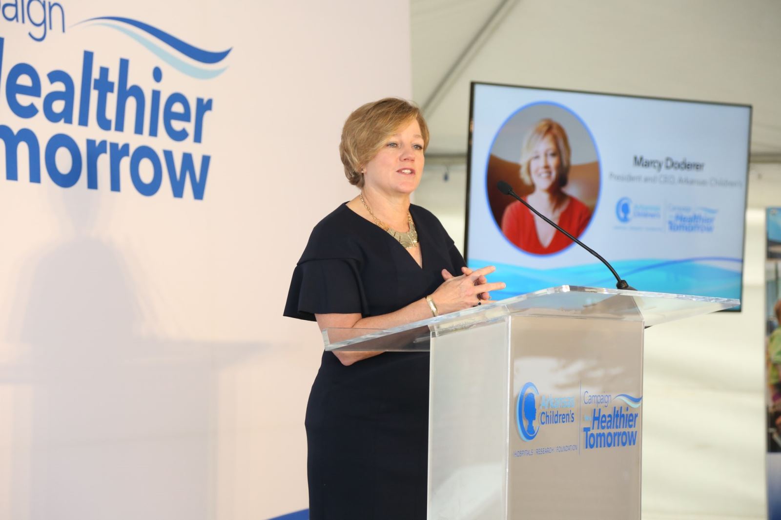 Photo of Marcy Doderer at podium