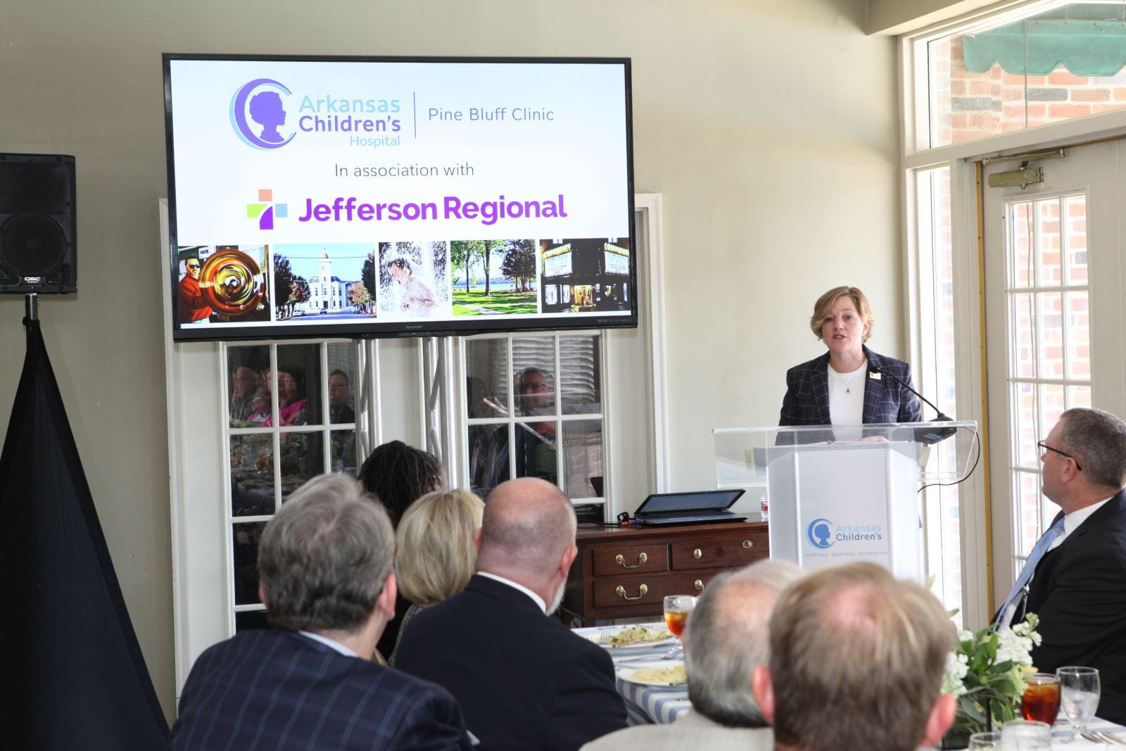 Photo of Marcy Doderer at podium