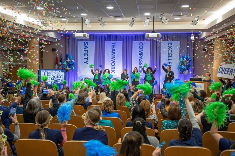 Room full of people celebrating with confetti