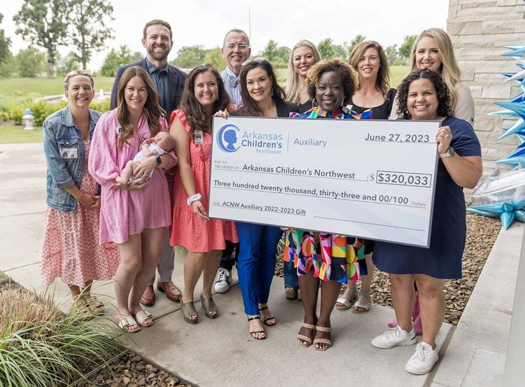 Group of people holding a check.