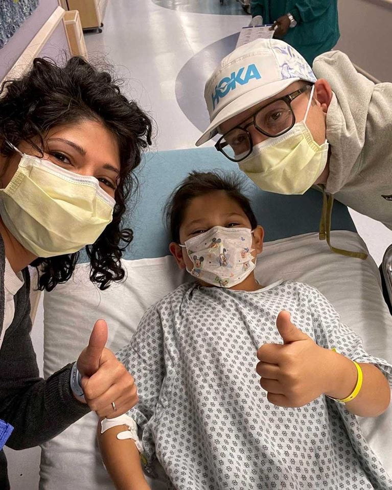 Patient and family giving thumbs up sign of hope.