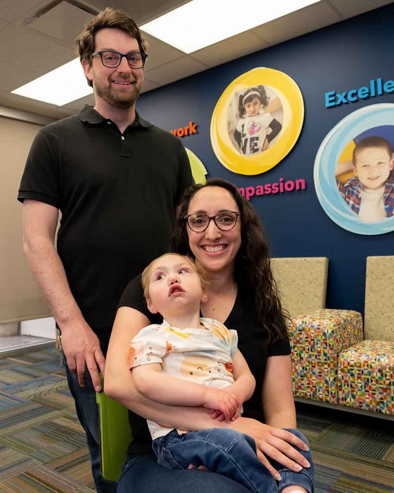 Foster family and child posing for photo.