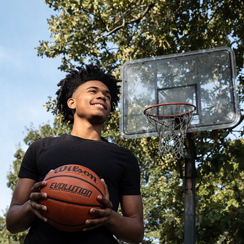 Photo of AC Patient, JT Taylor, holding basketball.