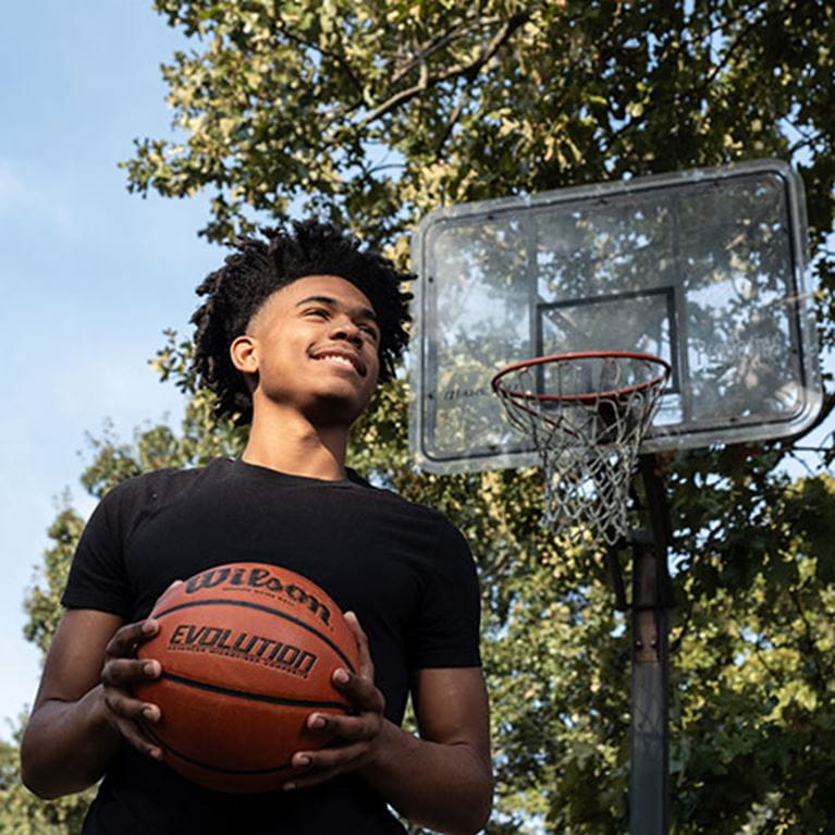 Photo of AC Patient, JT Taylor, holding basketball.