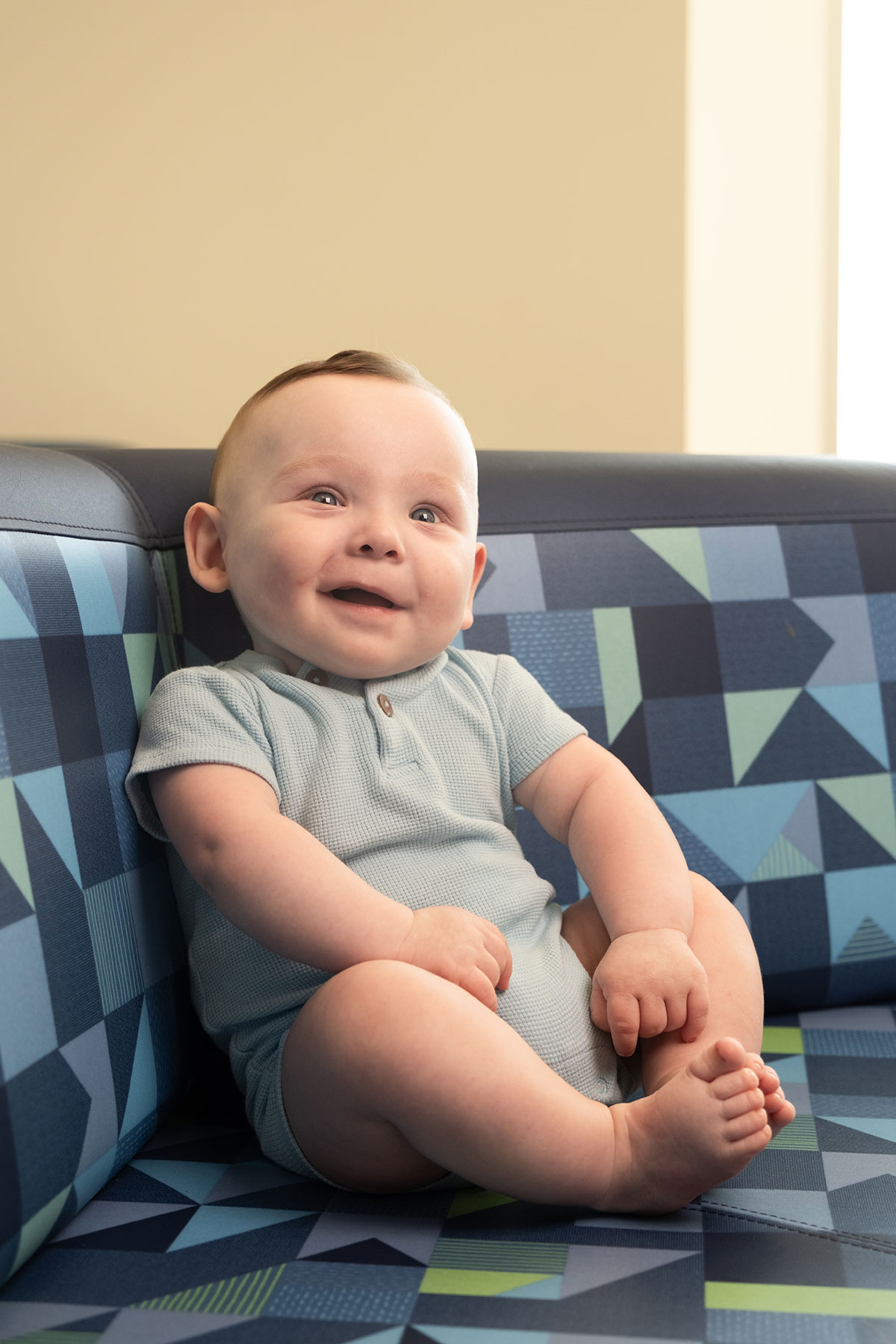 Baby boy wearing blue onesie and red hair