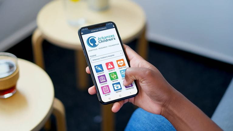 Photo of a person using the Arkansas Children's app